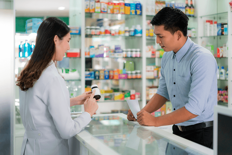 Female pharmacist explaining medicine to customer